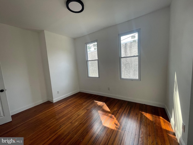 spare room with dark wood-type flooring