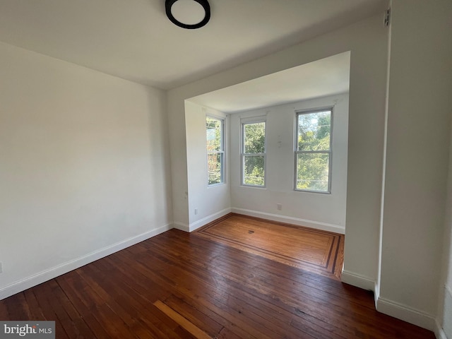 spare room with dark hardwood / wood-style floors