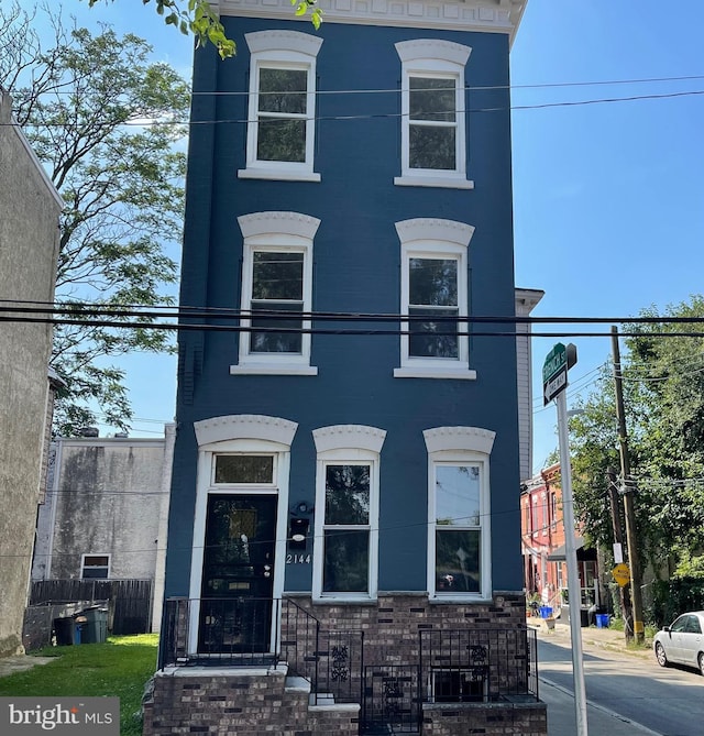 view of front of house with a fenced front yard and brick siding