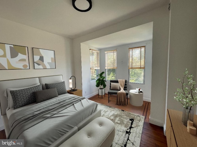 bedroom featuring baseboards and wood finished floors