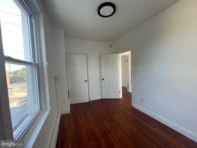 unfurnished bedroom featuring dark hardwood / wood-style flooring