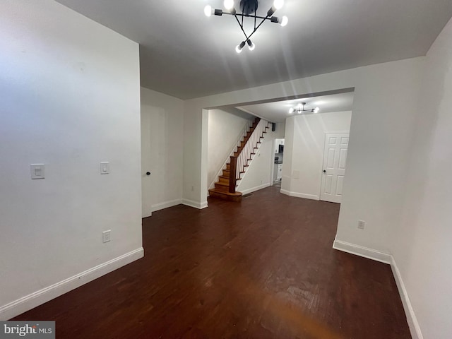 below grade area with stairway, wood finished floors, and baseboards