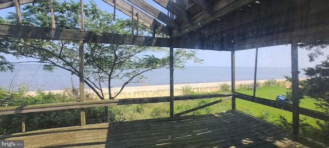 unfurnished sunroom with a water view