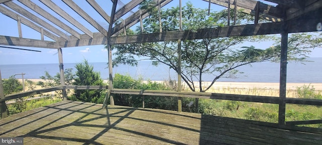 wooden terrace featuring a pergola and a water view