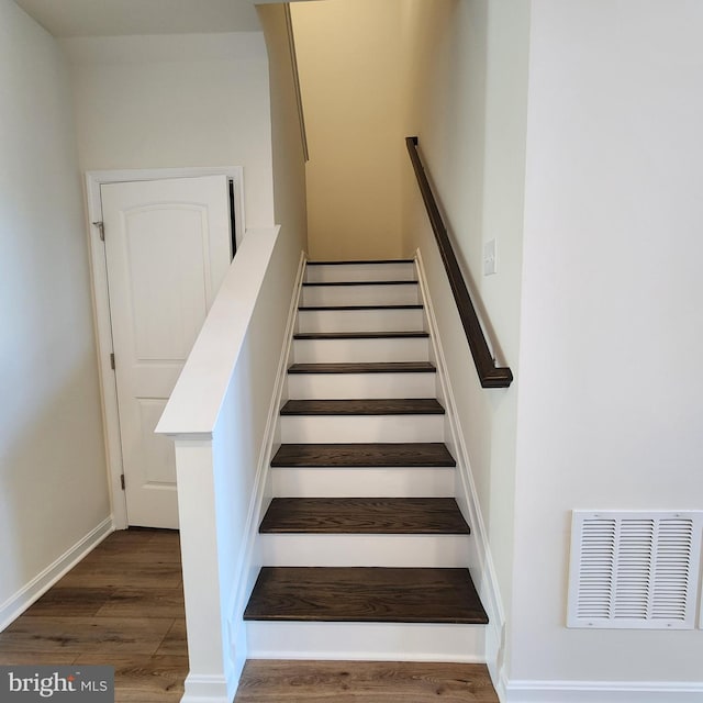 stairway featuring hardwood / wood-style flooring