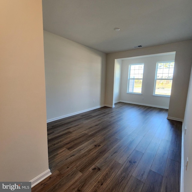 empty room with dark hardwood / wood-style floors