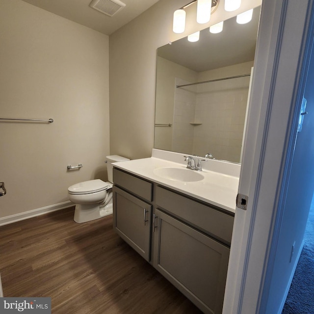 bathroom featuring hardwood / wood-style floors, vanity, and toilet