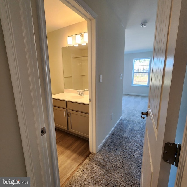 corridor with carpet and sink