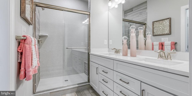 bathroom featuring vanity, wood-type flooring, and walk in shower