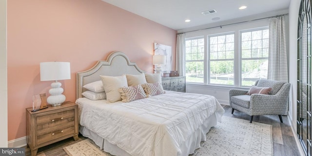 bedroom featuring hardwood / wood-style flooring and multiple windows