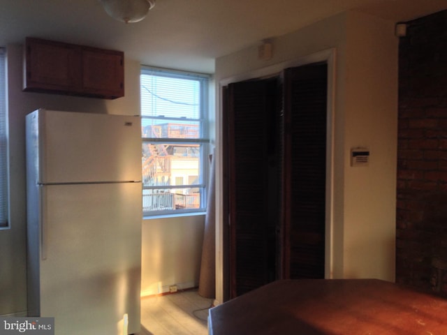 kitchen featuring light hardwood / wood-style floors and white fridge