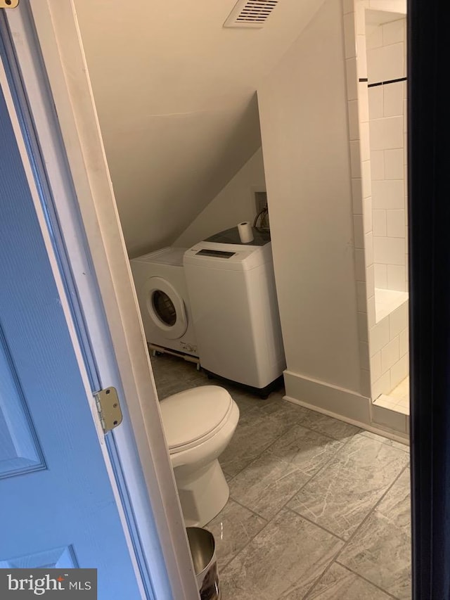 bathroom featuring tile patterned flooring, separate washer and dryer, and toilet