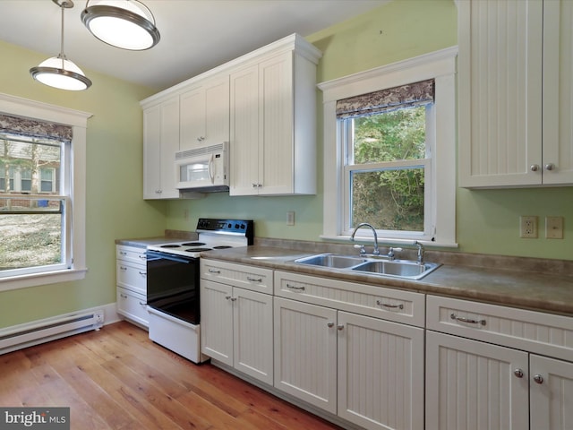 kitchen featuring light wood-type flooring, white cabinets, white appliances, and plenty of natural light