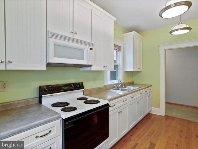 kitchen featuring white cabinetry, sink, range with electric stovetop, and light hardwood / wood-style flooring