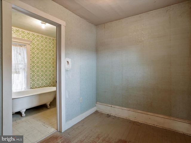 bathroom with a bathtub and hardwood / wood-style floors