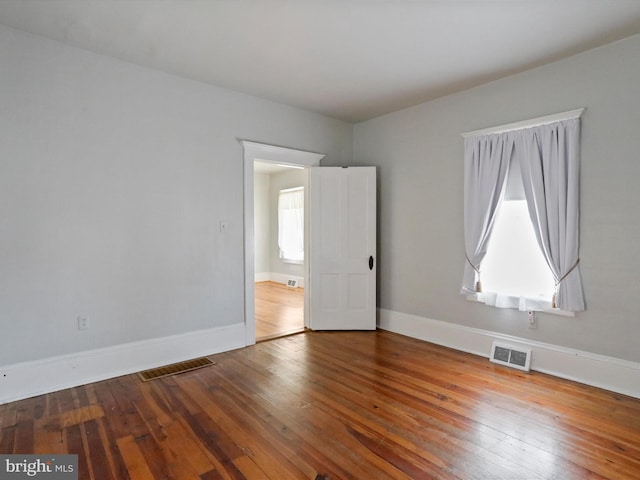 empty room featuring hardwood / wood-style flooring