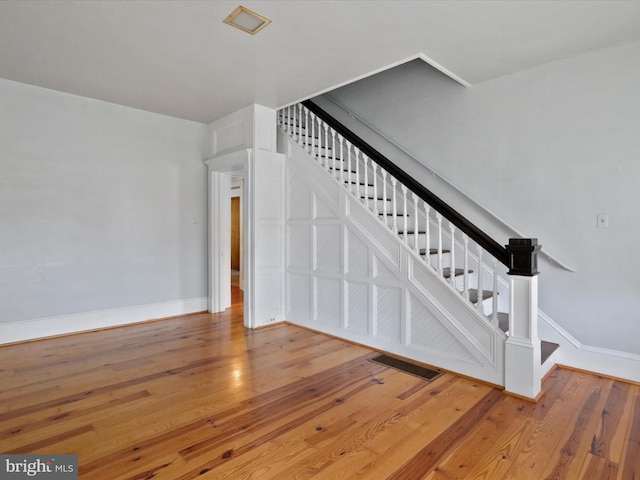 stairs featuring hardwood / wood-style flooring