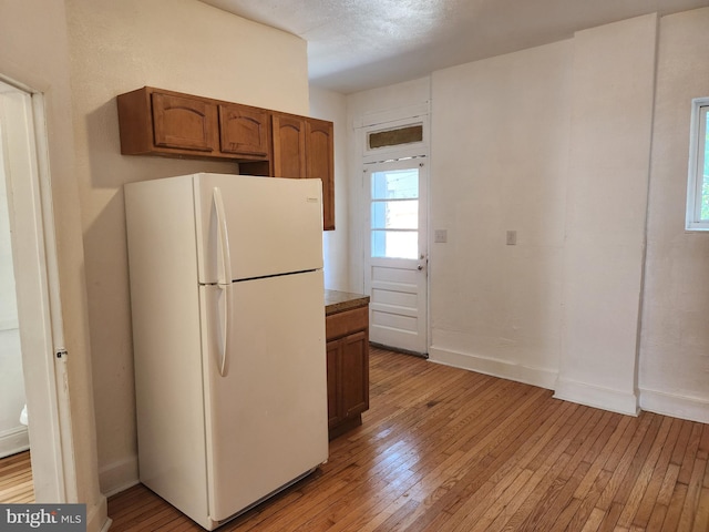 kitchen featuring light wood-type flooring and white refrigerator