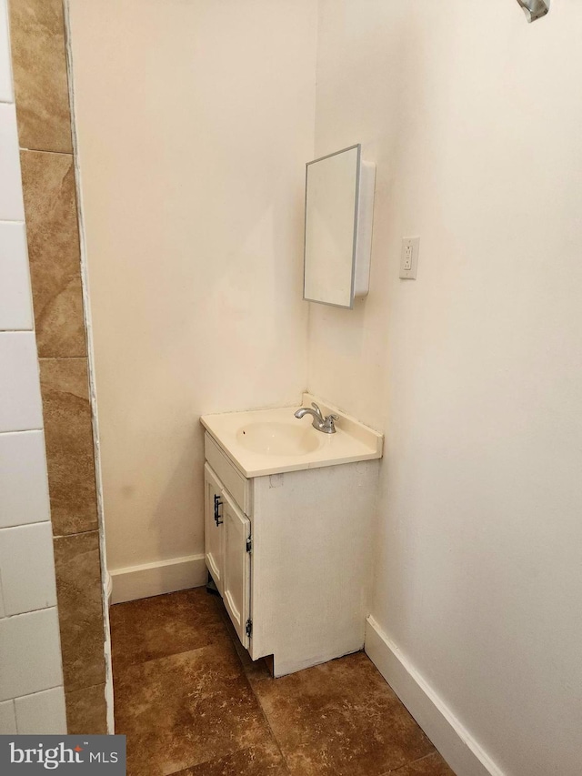 bathroom featuring vanity and baseboards