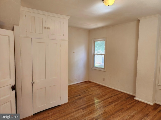 unfurnished bedroom with hardwood / wood-style flooring