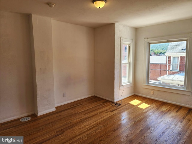 empty room with wood finished floors and baseboards