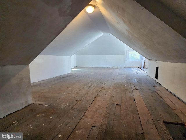 bonus room with lofted ceiling and light wood finished floors