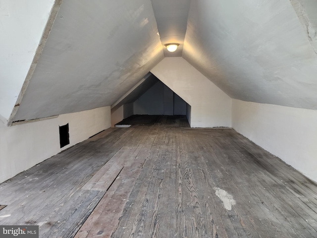 additional living space with lofted ceiling and wood finished floors