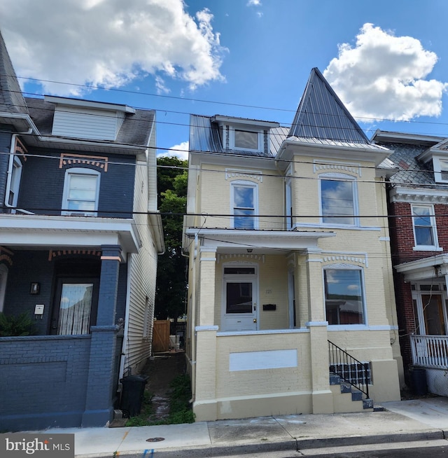 multi unit property with metal roof and brick siding