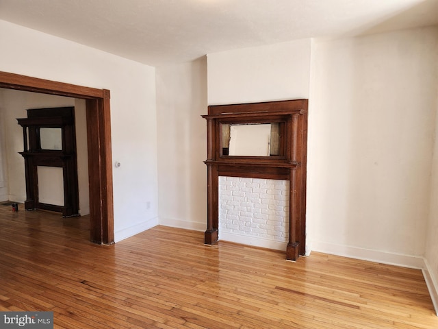 empty room featuring light wood finished floors and baseboards