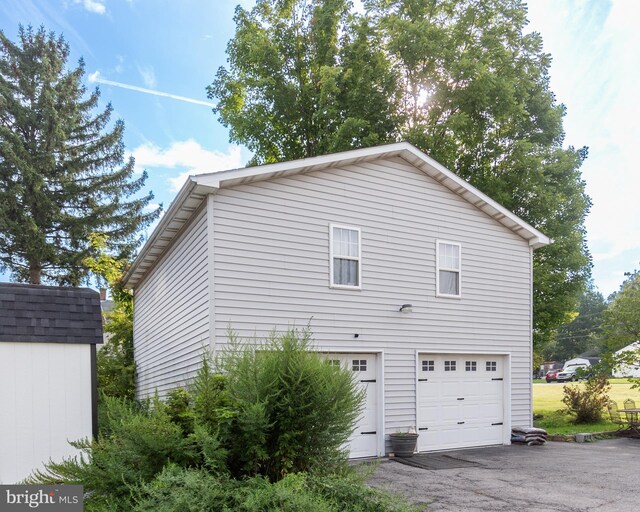 view of side of property with a garage