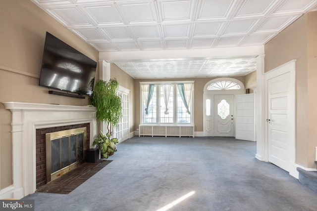 unfurnished living room featuring carpet flooring and radiator