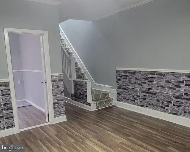 unfurnished living room with dark hardwood / wood-style floors and crown molding