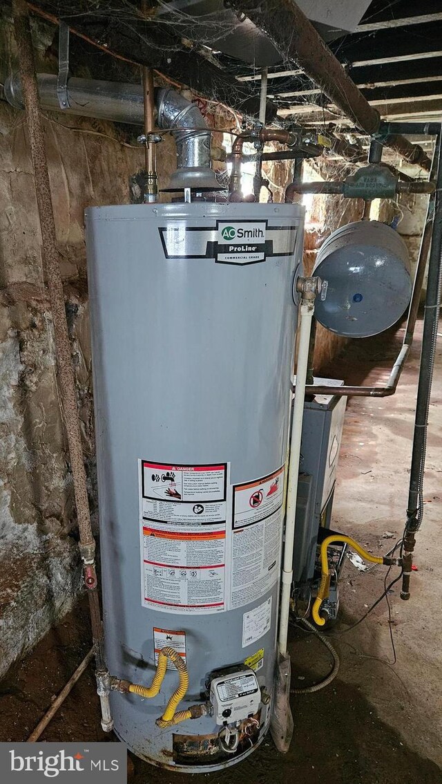 utility room featuring water heater