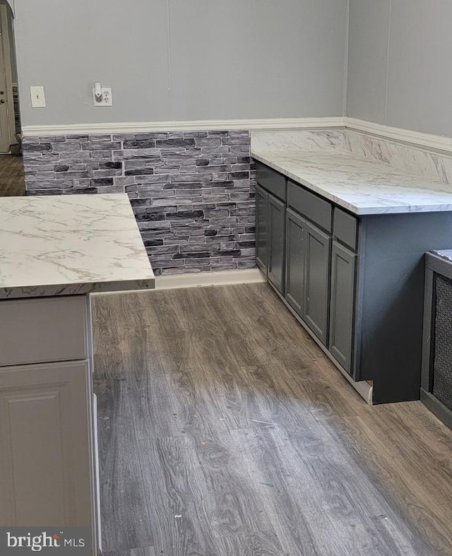 kitchen featuring gray cabinets and dark hardwood / wood-style flooring