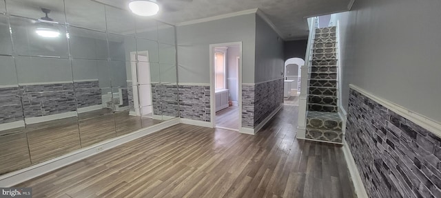 bathroom with crown molding, tile walls, ceiling fan, and hardwood / wood-style flooring