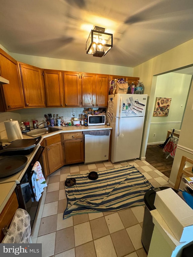 kitchen featuring light tile patterned floors, appliances with stainless steel finishes, sink, and tasteful backsplash