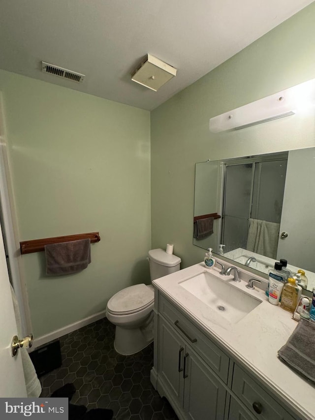 bathroom featuring tile patterned floors, vanity, and toilet