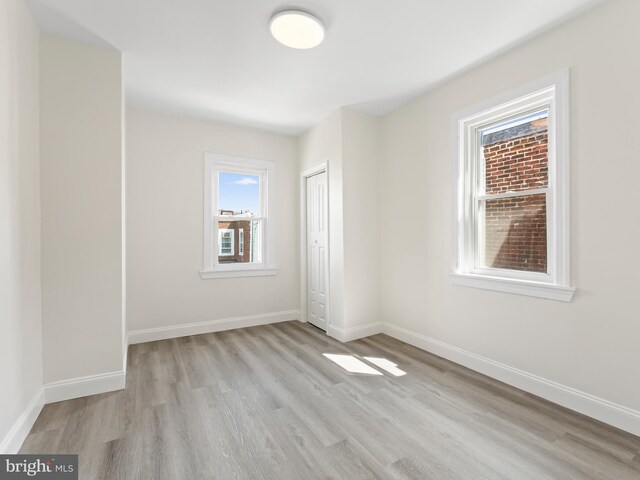 spare room with light wood-type flooring