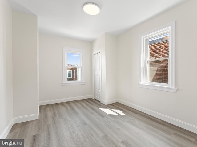 spare room with light hardwood / wood-style floors