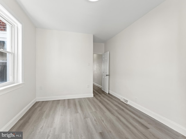 unfurnished room featuring plenty of natural light and light wood-type flooring