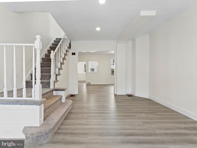 dining space with crown molding, plenty of natural light, and dark hardwood / wood-style flooring