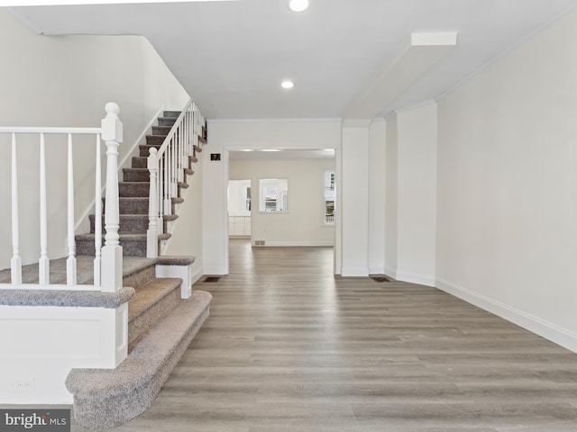 foyer featuring crown molding and hardwood / wood-style floors