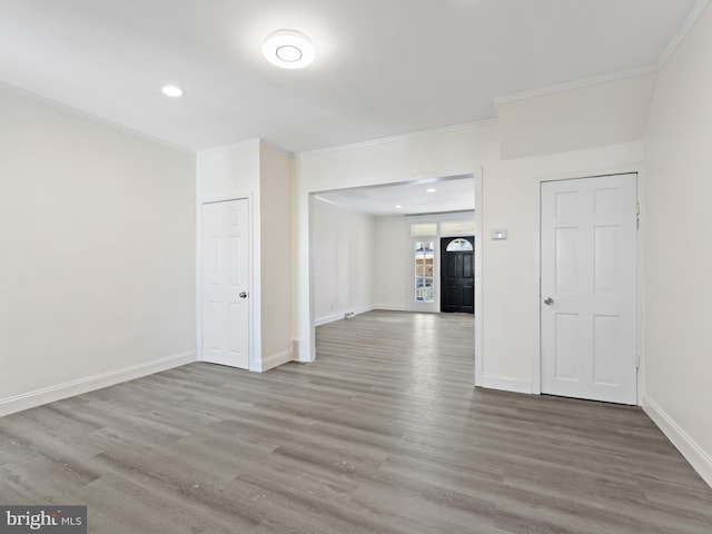 empty room featuring hardwood / wood-style flooring and ornamental molding