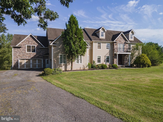 view of front of home featuring a balcony and a front lawn