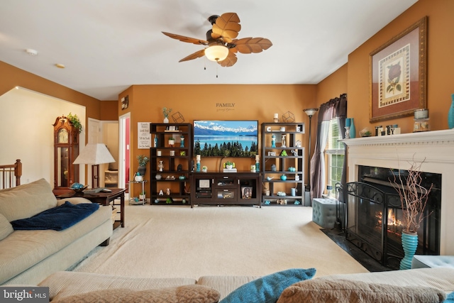 carpeted living room with ceiling fan