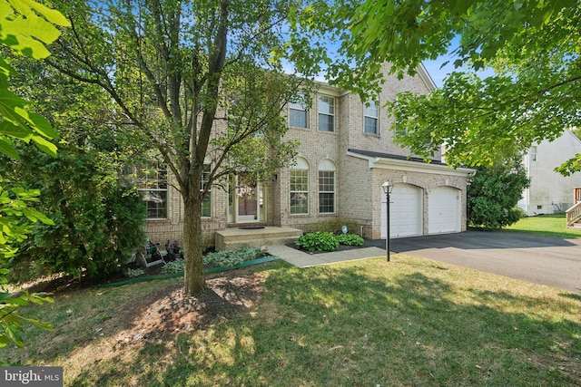 view of front of property with a garage and a front lawn