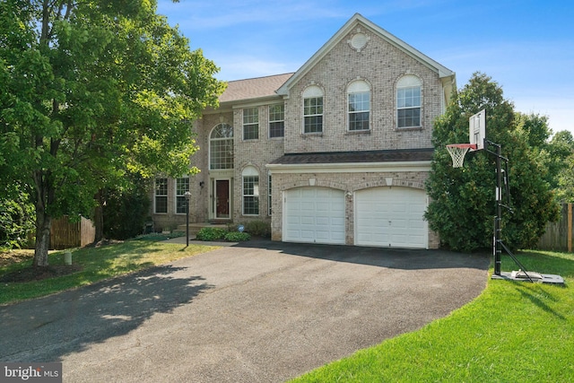 front of property with a front yard and a garage