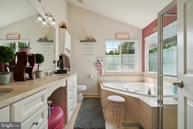 bathroom with toilet, vaulted ceiling, tile patterned flooring, tiled tub, and vanity