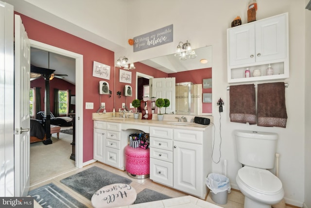 bathroom with toilet, a shower, vaulted ceiling, ceiling fan, and vanity