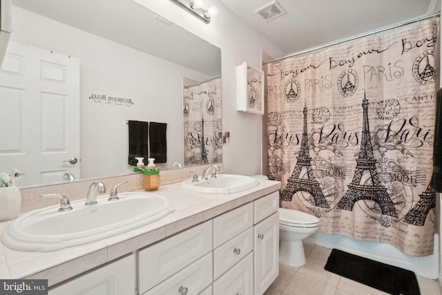 bathroom featuring toilet, tile patterned flooring, vanity, and walk in shower